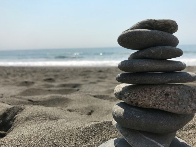 Stack of stones on beach during daytime